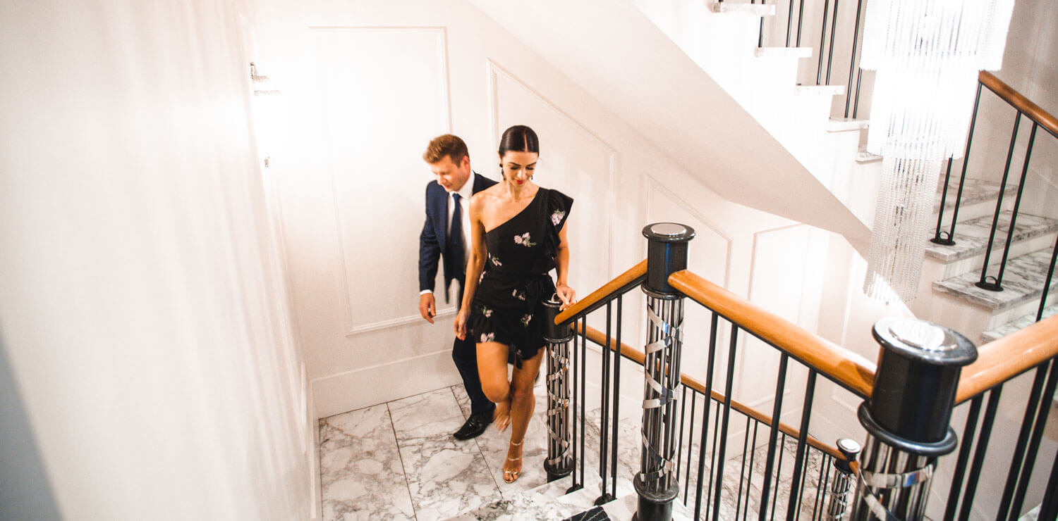 man-and-woman-walking-up-hotel-stairs | The Savoy Hotel on Little Collins